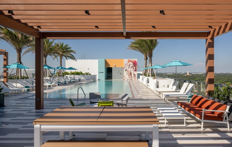 Indulge in the Miami sun on our expansive pool deck, offering luxury seating - Core At Link