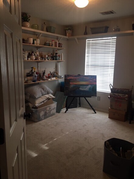 Bedroom 3 - This has been an art room, but is Bedroom, with sliding door for closet. The shelves can remain, or be removed (3 lower shelves), The upper shelf that surrounds the room, is permanently installed. - 3809 Willie Mays Ln