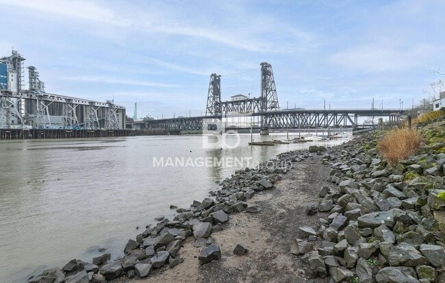 Building Photo - Spacious Riverfront Condo- Beautiful Condo w/River View from Bedroom! Parking Included!