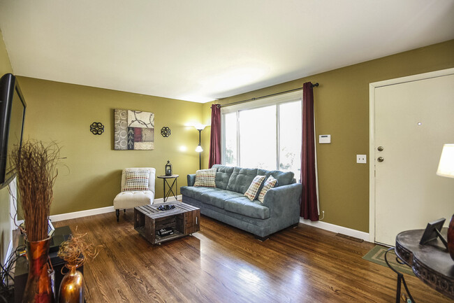 Photo 4. Living Room with gleaming hardwood floors, and front door - 1623 Lethia Dr