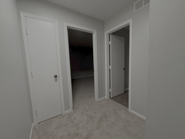 Neutral-toned hallway with fresh carpeting connects to the upstair bedrooms - 7778 Willowcove Ct