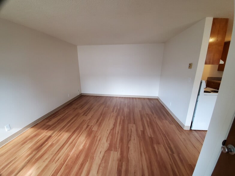 1 BEDROOM: family room from front door - Wolfpack Village Apartments