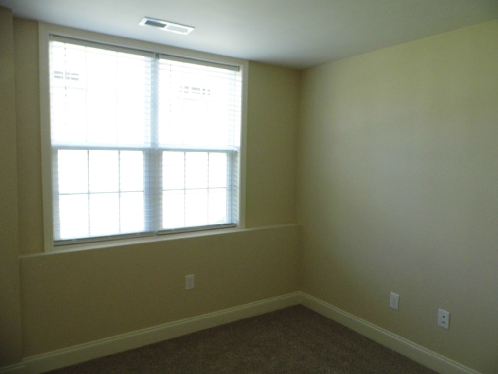 The second bedroom has a large window with plantation blinds for a peaceful sleep - 2312-A Belle Ave NE