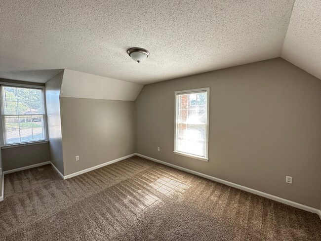 Building Photo - Charming 3BR/2BA Near Southwind | Hardwood Floors, Brick Fireplace, Bay Window & 2-Car Garage