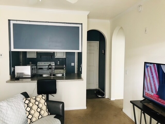 Living room Facing front door and kitchen - 860 N Orange Ave