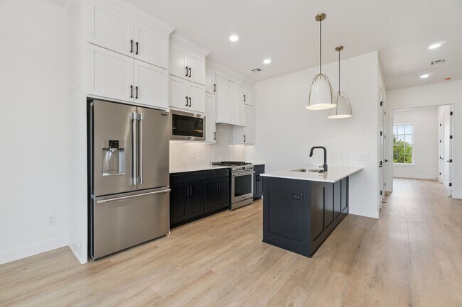 Building Photo - Bright. Clean. Calm. Your Elevated One-Bed...
