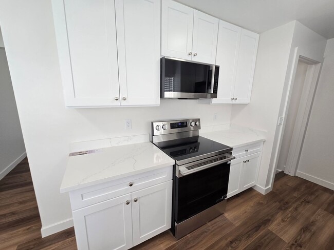 Building Photo - Remodeled 4 Bed, 2 Bath with Double Kitchen & Covered Carport