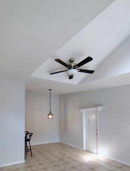 Dining room by entry door, new ceiling fan over LR - 1353 Pine Ridge Cir E