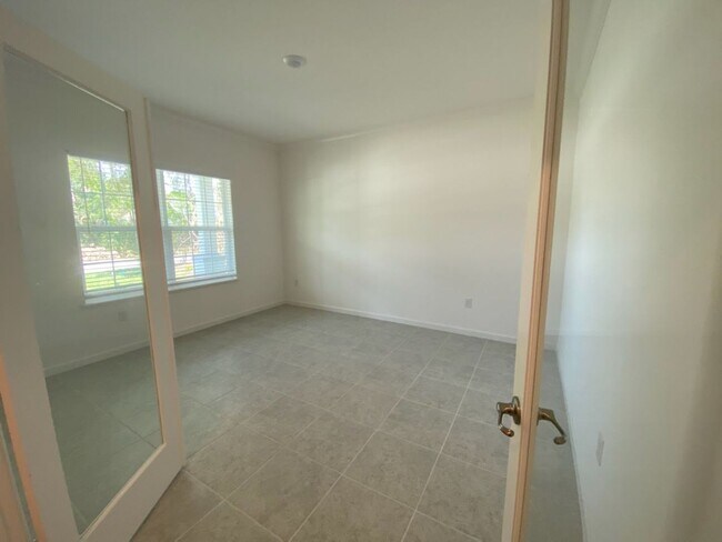 Building Photo - Like New 3 bedroom + den with French doors...