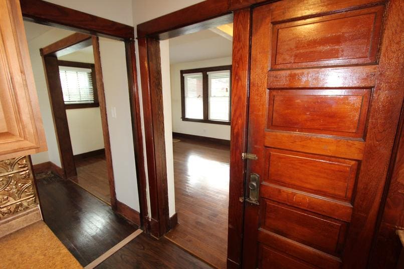 View from the kitchen into the family room and dining room. The door on the right is to the basement. - 2038 Stonelea St