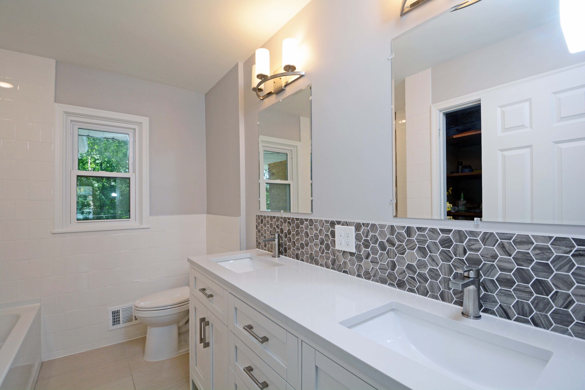 Bright, updated main bathroom featuring new double bowl vanity - 5206 Grandview Ln