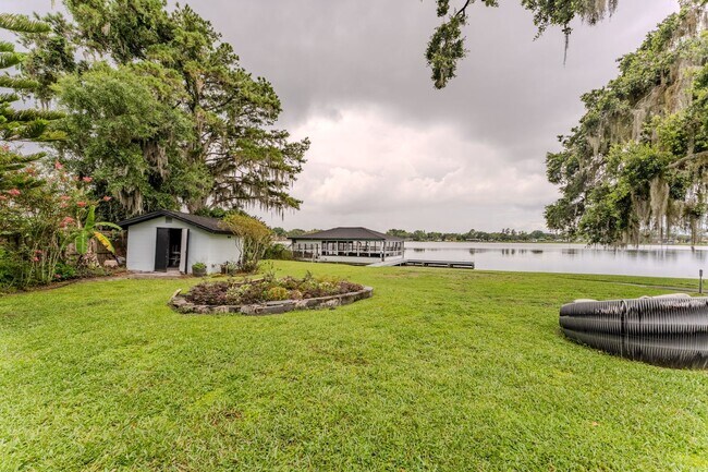 Building Photo - Lake Jessamine Luxury: Solar-Powered Waterfront Retreat on 1.14 Acres with Dock & Boathouse