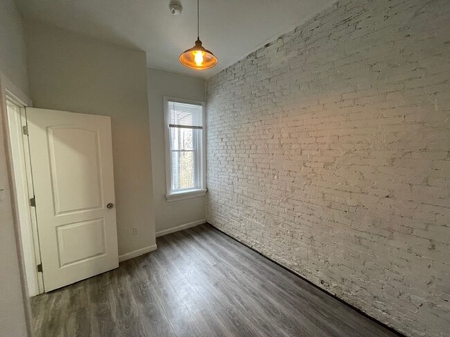 Building Photo - Modern 3-Bedroom Home with Exposed Brick &...