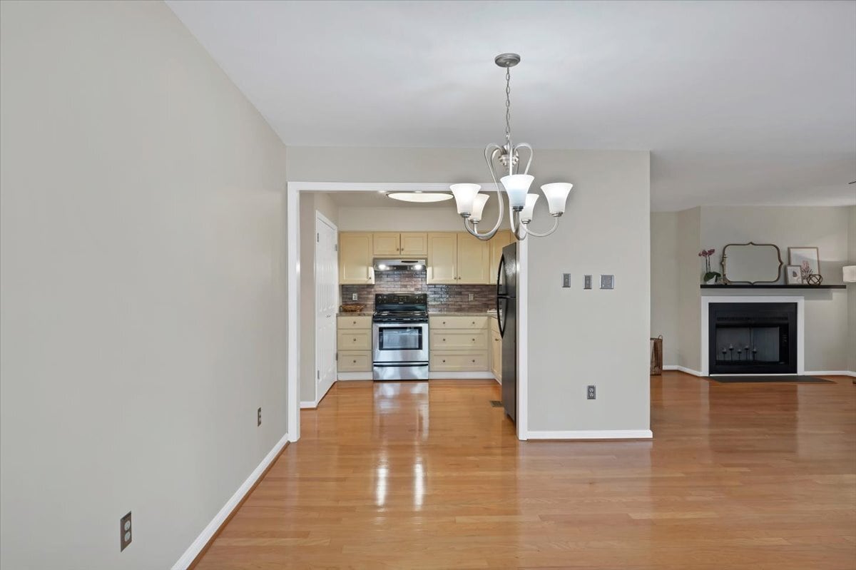 Kitchen left - Living room with fireplace right - 10 Pinehurst Manor Dr