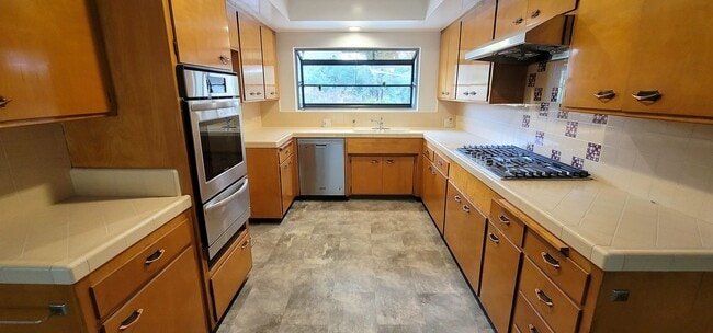 Building Photo - Classic, Midcentury 3 bedroom with Den, 2.5 bath home nestled into hillside with secluded backyar...