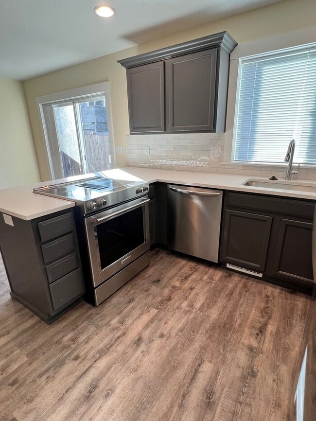 Building Photo - Remodeled Home with New Flooring, Quart Counters, W/D, Fenced Yard, Parking & MORE!