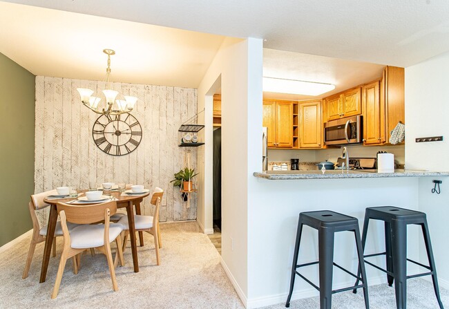 Dining table and split level kitchen countertop with bar stools provide plenty of options for places - 24137 Del Monte Dr