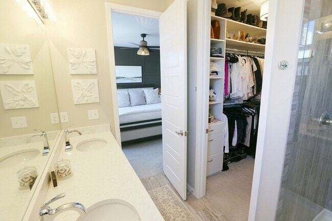 Master bathroom with double vanity and custom walk in closet. - 15637 E Broncos Pl