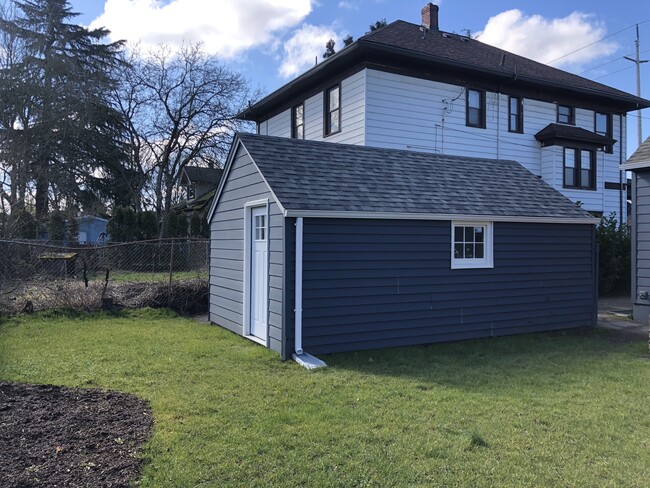 Outdoor storage for bikes, etc. is provided for both units in the garage. The garage is divided on the interior to create two separate storage areas and access for the studio-dedicated storage is through the rear, lockable, door. - 4842 NE Mallory Ave