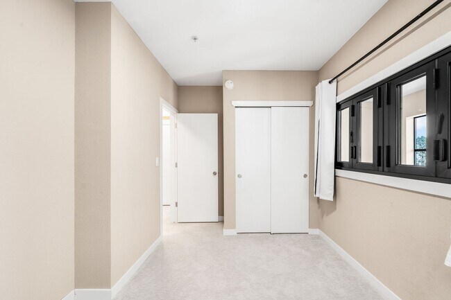 Building Photo - Modern 2BD, 1.5BA Condo with 20' Ceilings and Garage Parking Spot