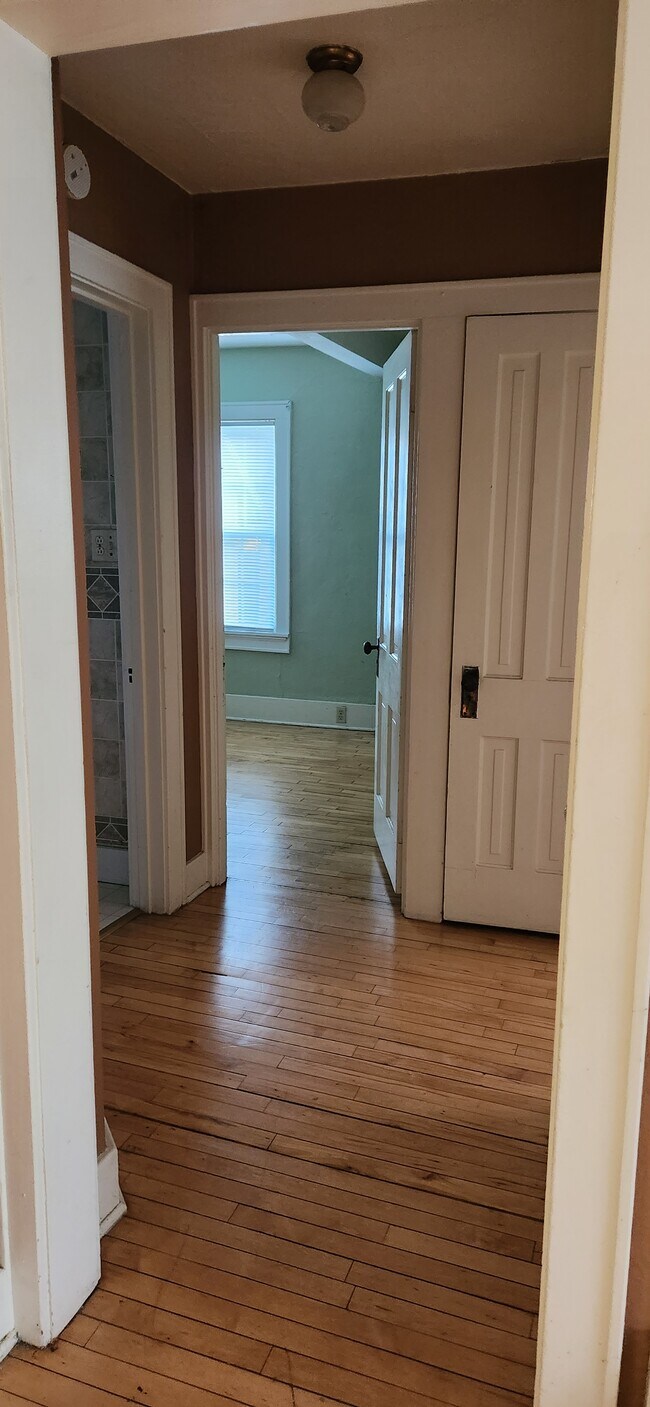 Hallway by bedrooms, bathroom and into the dining room. - 2101 Ellis St