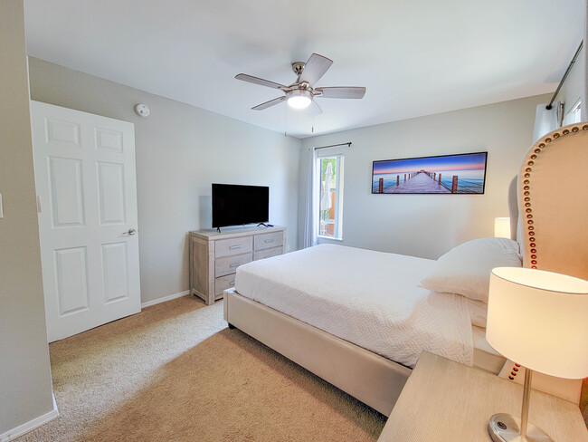 Natural light is abundant in the bedroom, and the nightstands include lamps with USB ports. - 3500 N Hayden Rd