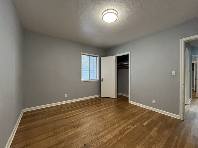 Building Photo - Three-Bedroom Home with Updated Kitchen & Vaulted Ceilings, large open basement, Hardwood floors