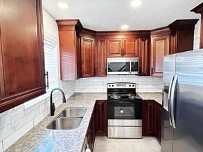 Building Photo - Newly Renovated 2/1.5 Condo in Gated Commu...
