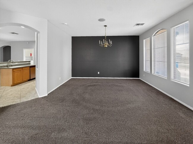 Building Photo - Single-level 4 bed, 2 bath home with tandem 3-car garage and RV gate.