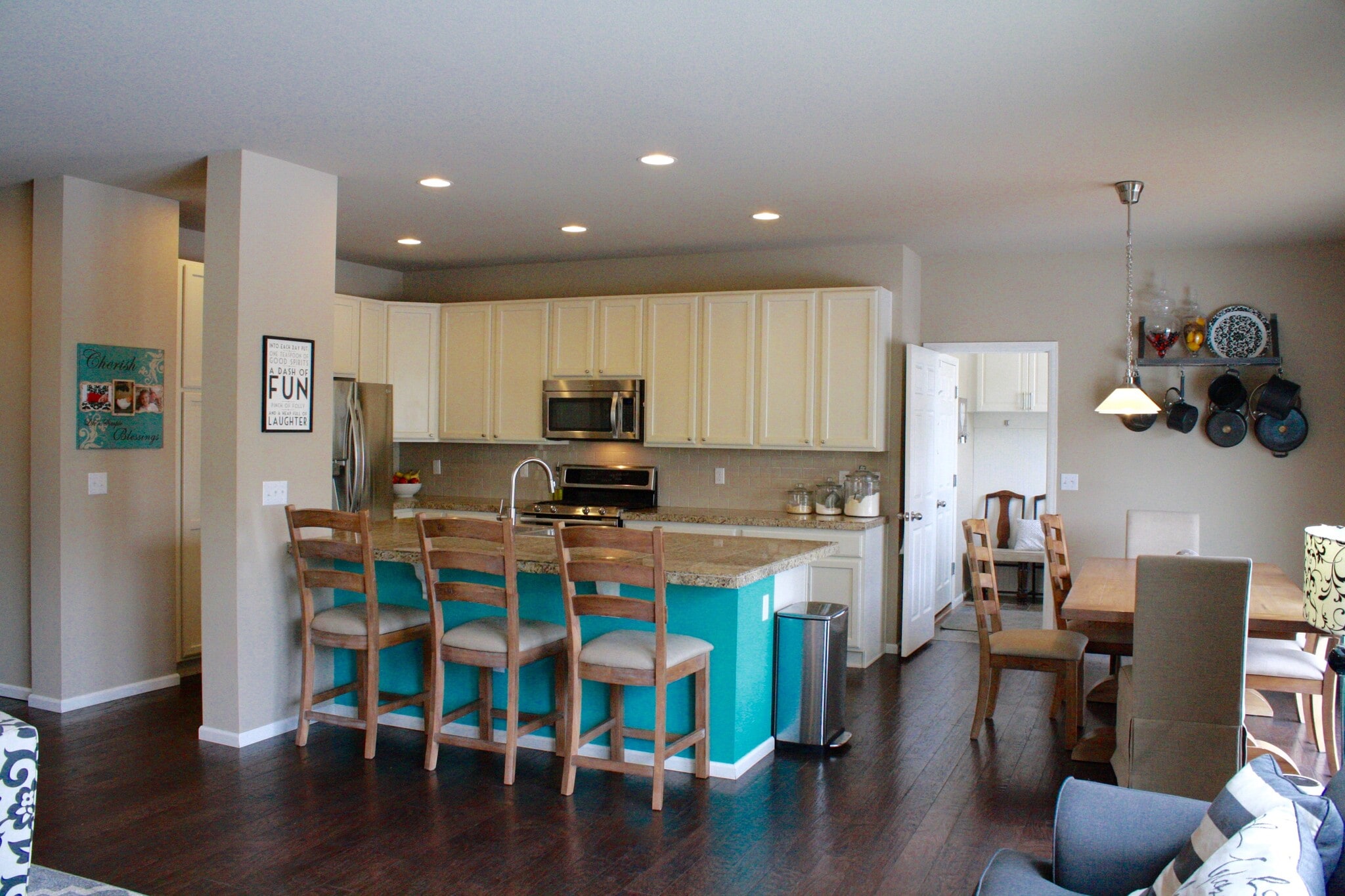 Kitchen and dining from living space view. Laundry/mudroom through door then garage entrance - 5132 Exploration Lane