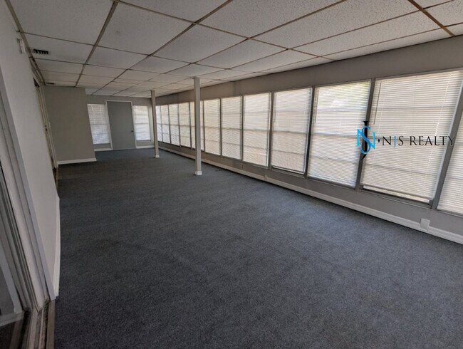 Building Photo - 2/2/1 with  RENOVATED baths & kitchen, fenced yard, NEW lvp flooring and a OVERSIZED lanai!