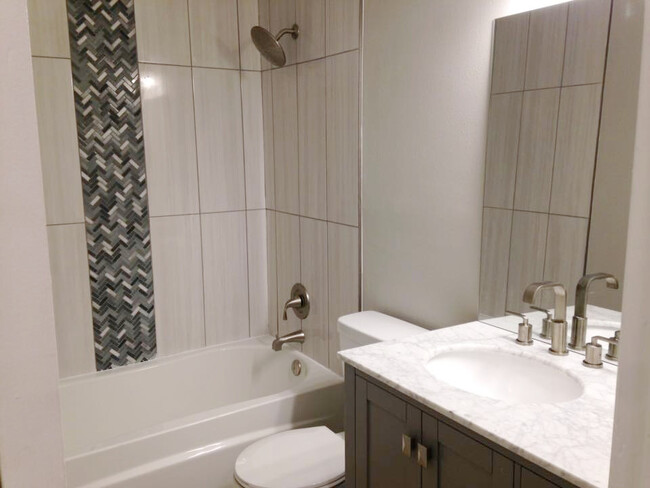 Beautiful tile bathroom with marble vanity - 11401 Ptarmigan Dr