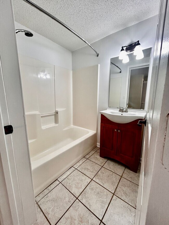 Building Photo - NOW AVAILABLE! 3 Bedrooms/1 1/2 Bath with Double living room space.