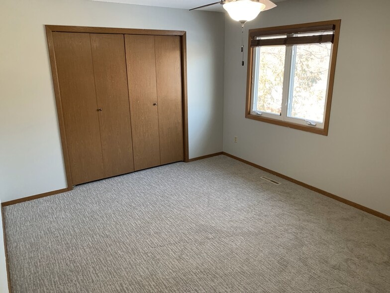 Spacious second-floor bedrooms with brand-new carpet and large windows offering natural light and st - 4903 W Kirkwood Cir