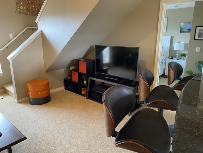 Living room towards stairs, table/stool and TV+storage unit - 3706 Lower Honoapiilani Rd