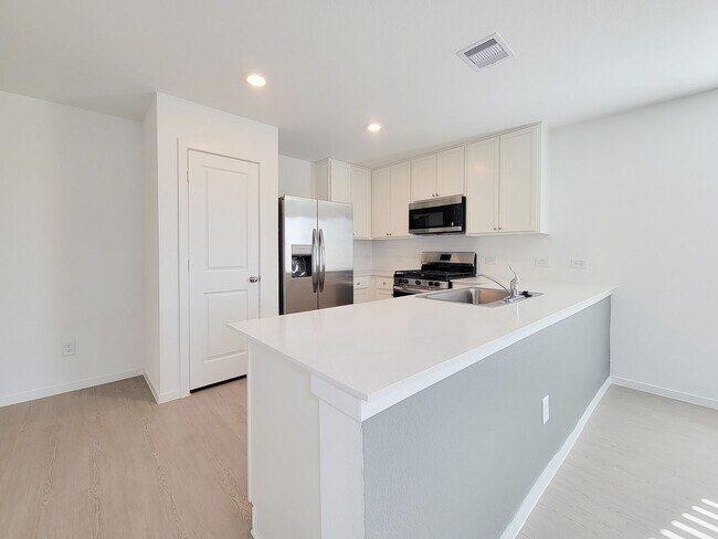 Building Photo - This single-level home showcases a spacious open floorplan shared between the kitchen, dining are...