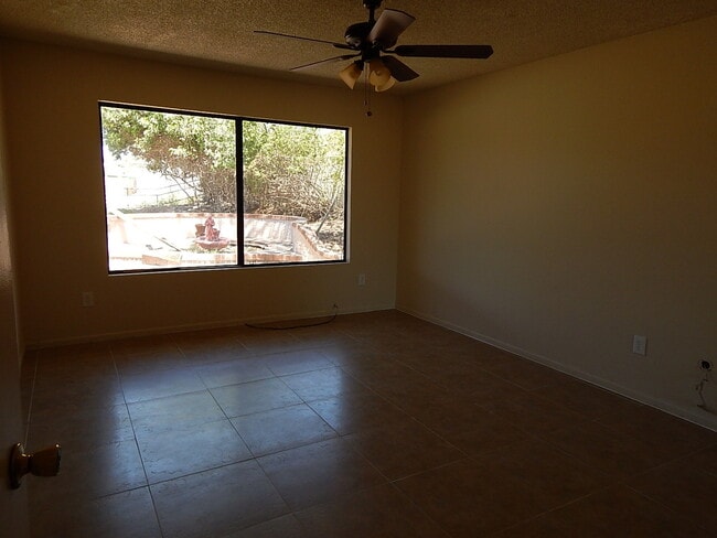 Building Photo - This property is a 3 bedroom, 2 bathroom home featuring an open floor plan with tile throughout. ...