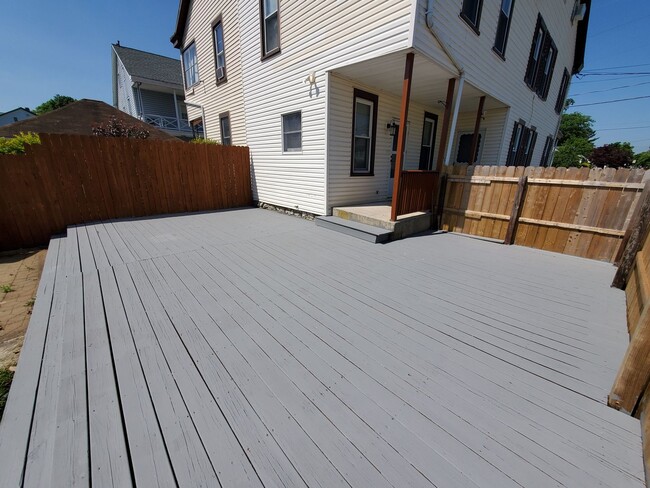 Building Photo - Pet friendly duplex w brand new kitchen & first floor LVP, basement, fenced yard, deck, near comm...