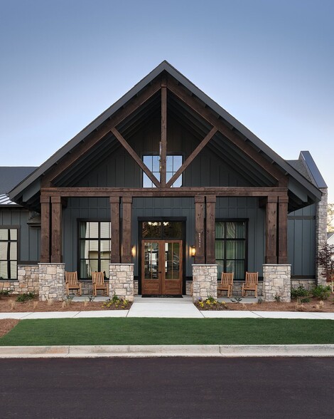 Clubhouse exterior with ample parking for future residents and visitors. - The Bend at Pettit Creek
