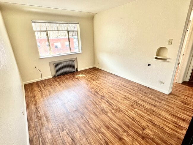 Experience the warmth and charm of this sunlit room, perfect for creating your dream living area. - Hillside Apartments