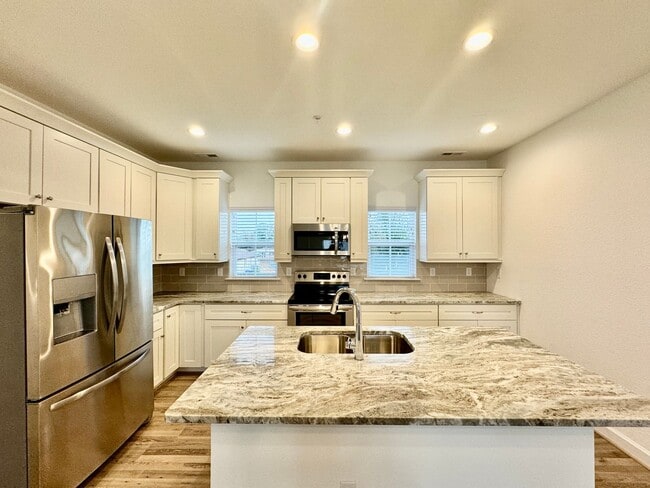 Building Photo - Practically New & Available NOW! Americana Luxury Townhomes! Pet Friendly! Attached Garage! All A...