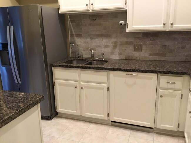 Kitchen sink area with porcelain stone finish backsplash - 1103 Dulles Ave