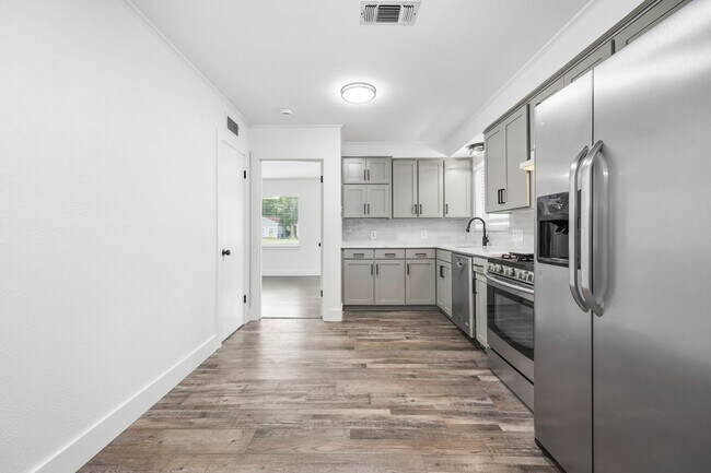 Building Photo - **$40K+ IN UPGRADES AND A FENCED BACKYARD WITH TWO STORAGE BUILDINGS**