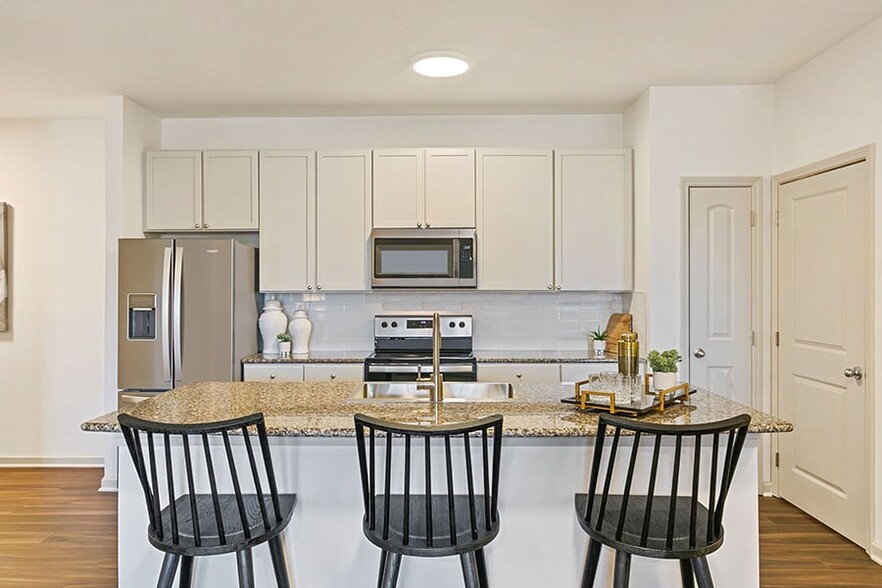 Beautifully renovated kitchens feature granite countertops, over-sized tile backsplash and smooth-top range - Chancery Village