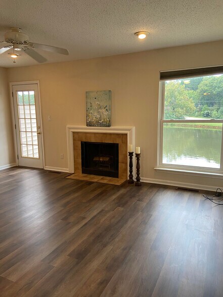 LVP flooring in living room and wood burning fireplace. - 3812 Summerwood Ct