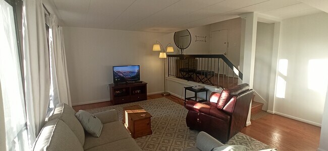 Open layout living, kitchen, and dining area - 100 Roberts Ln