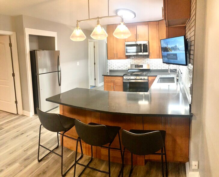 Built in refrigerator, three counter height chairs included. - 771 56th St