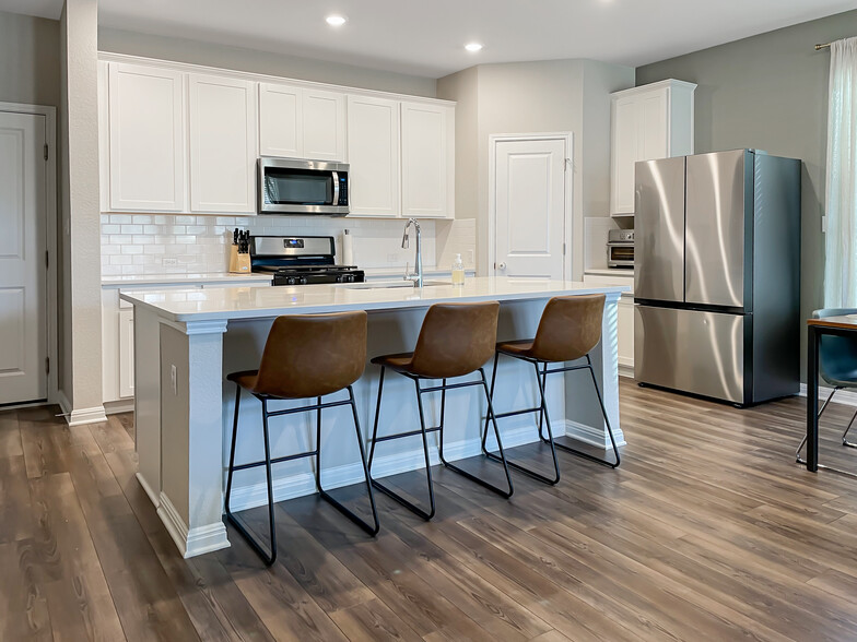 Dining area with counter height bar top, large corner pantry, and stainless steel appliances - 897 Lone Peak Way