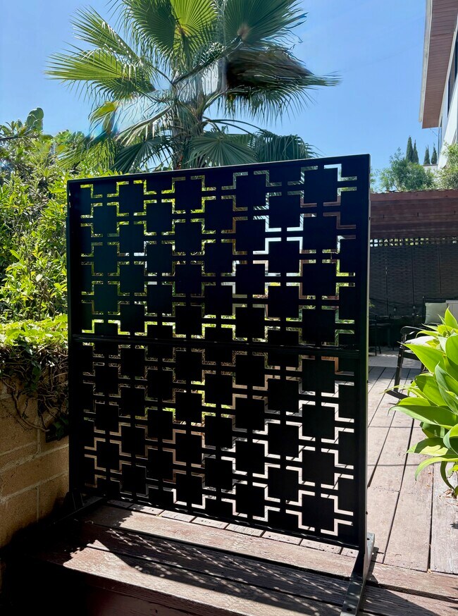 Privacy screen creates a more secluded outdoor retreat. - 1672 Rotary Dr