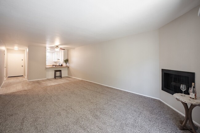 Living room with fireplace and kitchen - Oak Park Apartments